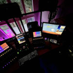Dolby Atmos control desk with Avid control surfaces and monitors glowing at night at Sonic Forest Studios